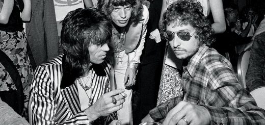 Bob Dylan in mirrored aviator sunglasses, Keith Richard in Granny Takes a Trip Jacket, Mick Jagger hovering overhead